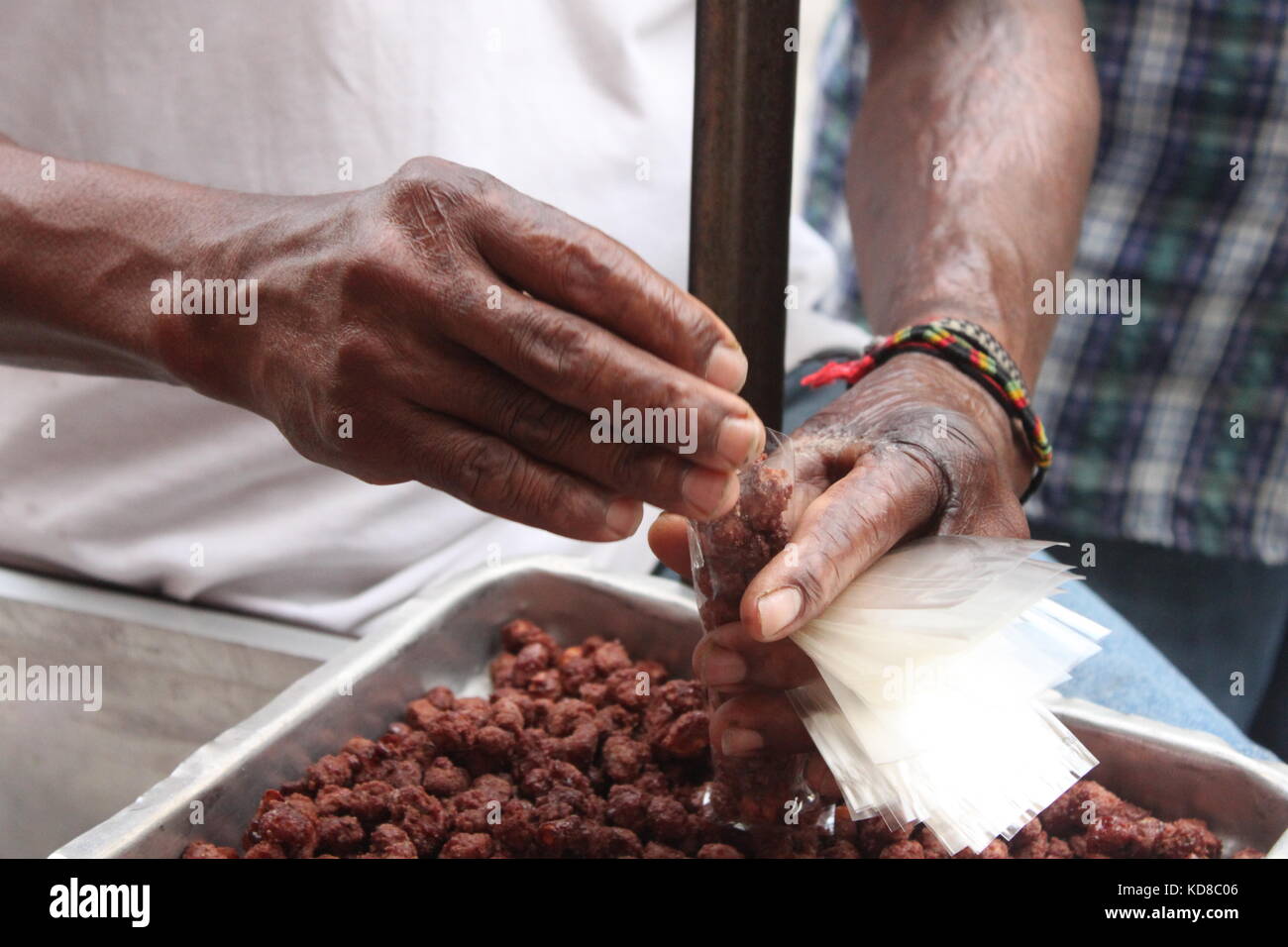 Brazilian street food vendor, packing sugar coated peanut Stock Photo