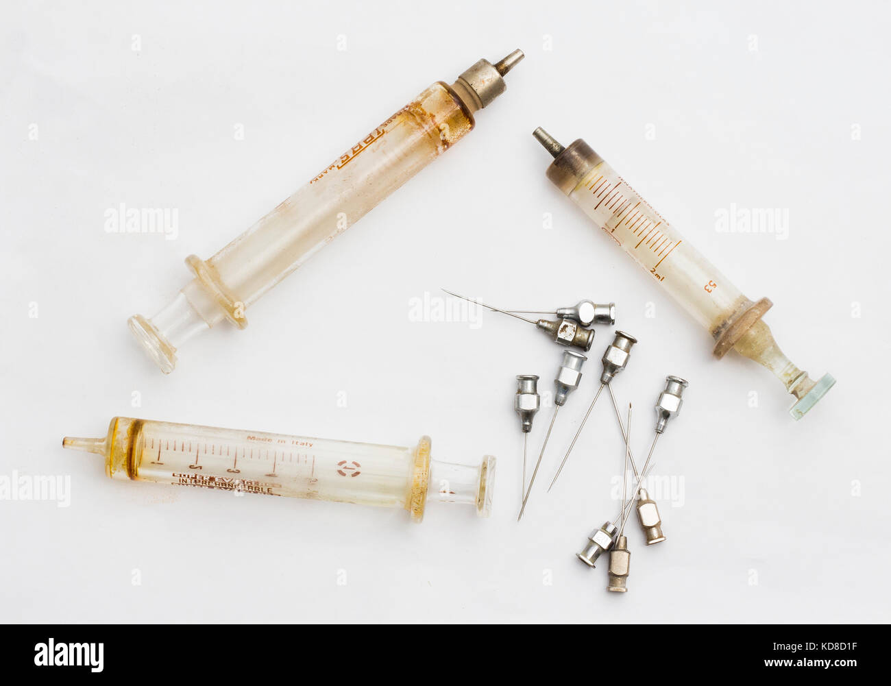 Collection of antique medical instruments, glass syringes, needles in