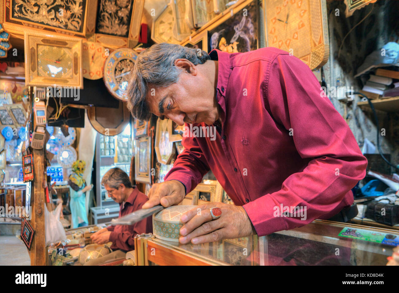 Fars Province, Shiraz, Iran - 19 april, 2017: Art workshop at the Vakil bazaar, the artist produces handiwork for sale in the shop of artistic product Stock Photo