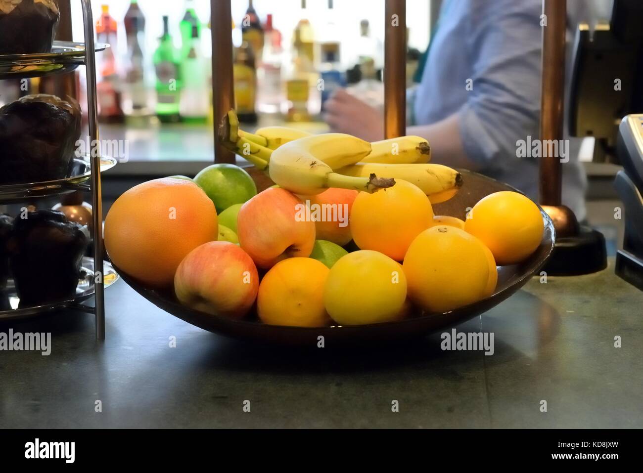 A bowl of fresh fruit on the counter of an airport restaurant. Stock Photo