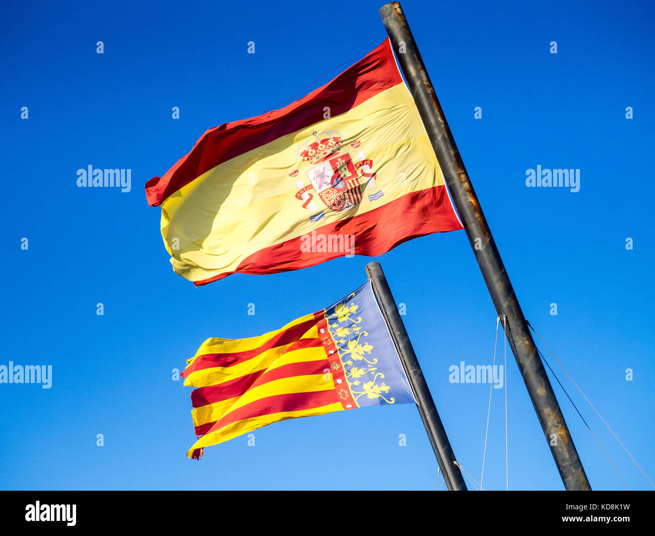 Spanish and Valencian Flags fly near Valencia Harbour and beach in Valencia Spain Espana Stock Photo