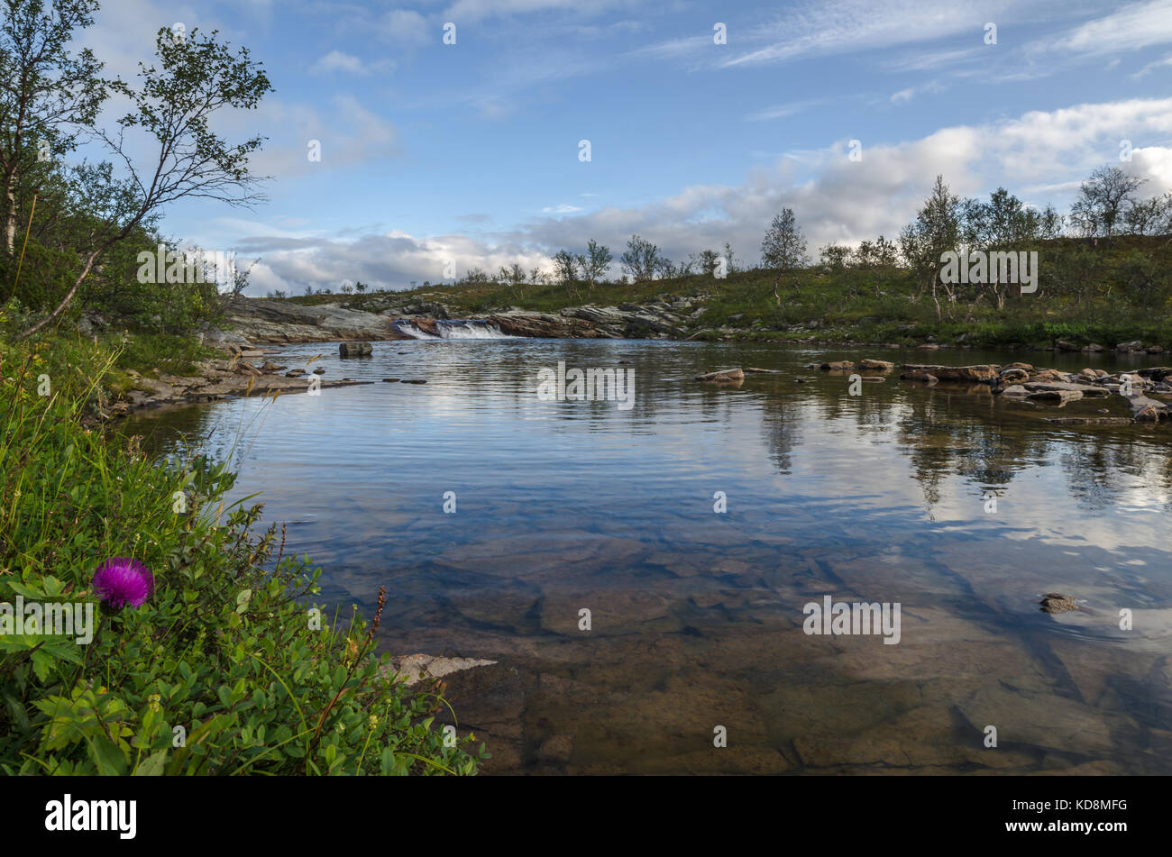 Small river with tiny waterfall in distance, in Finnmark Norway Stock Photo
