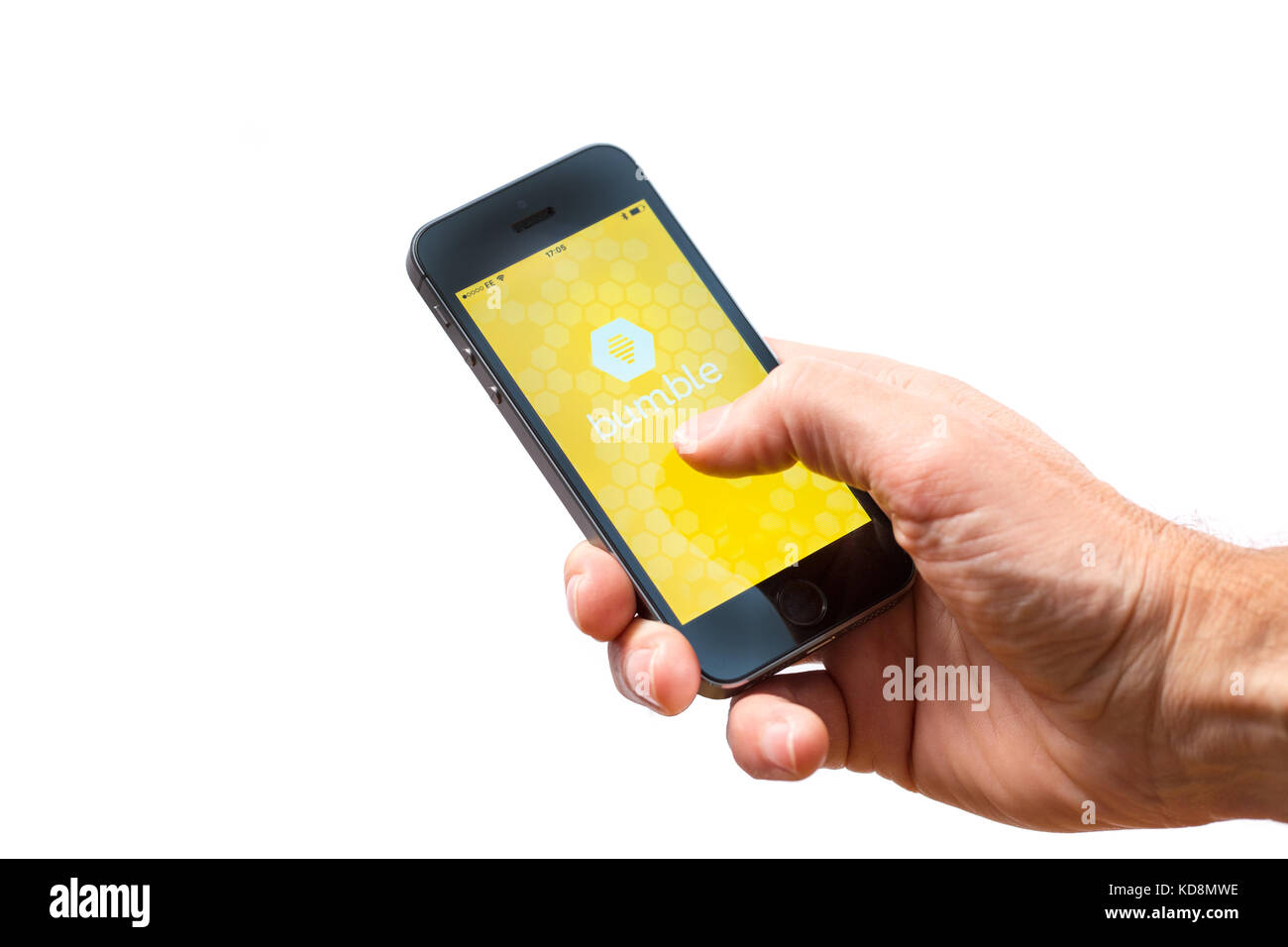 A man using Bumble, a dating app on a mobile phone Stock Photo