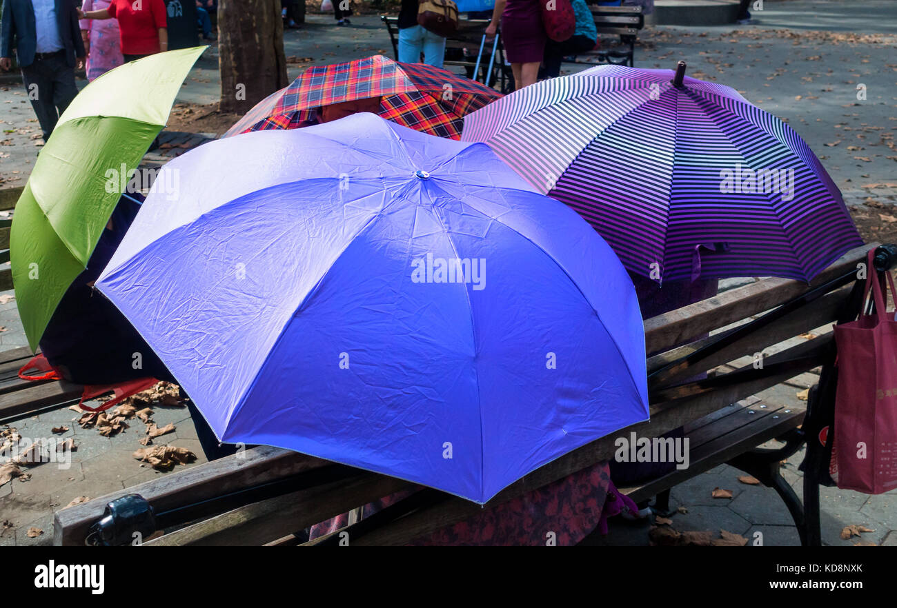 Asian women using umbrellas to protect from the sun not the rain Stock Photo