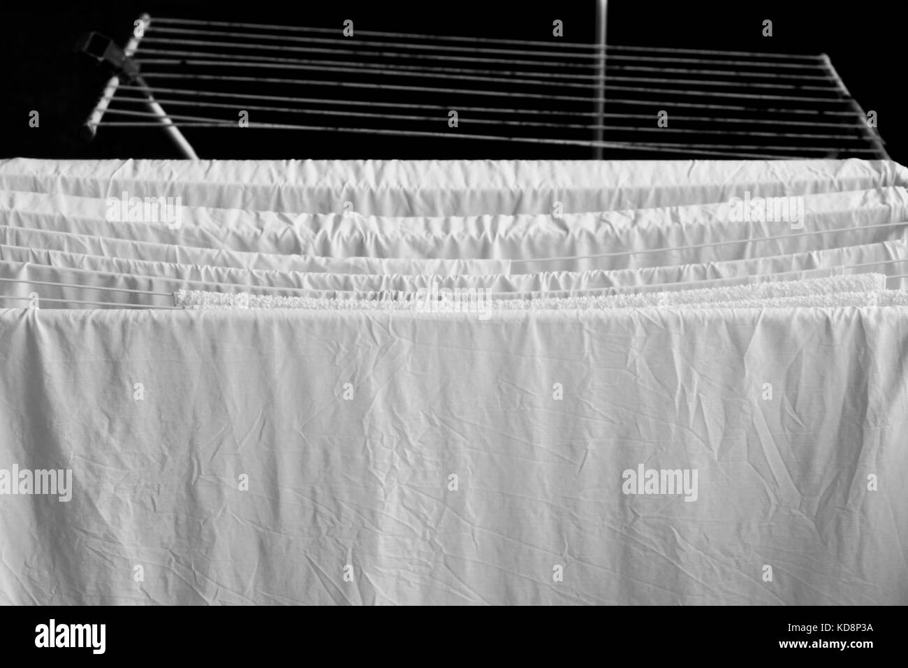 black and white picture of the floor dryer for towel and sheets in the