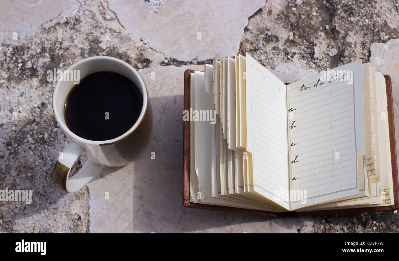 coffee mug and a small notebook to do list with space to put your own text,blank paper Stock Photo