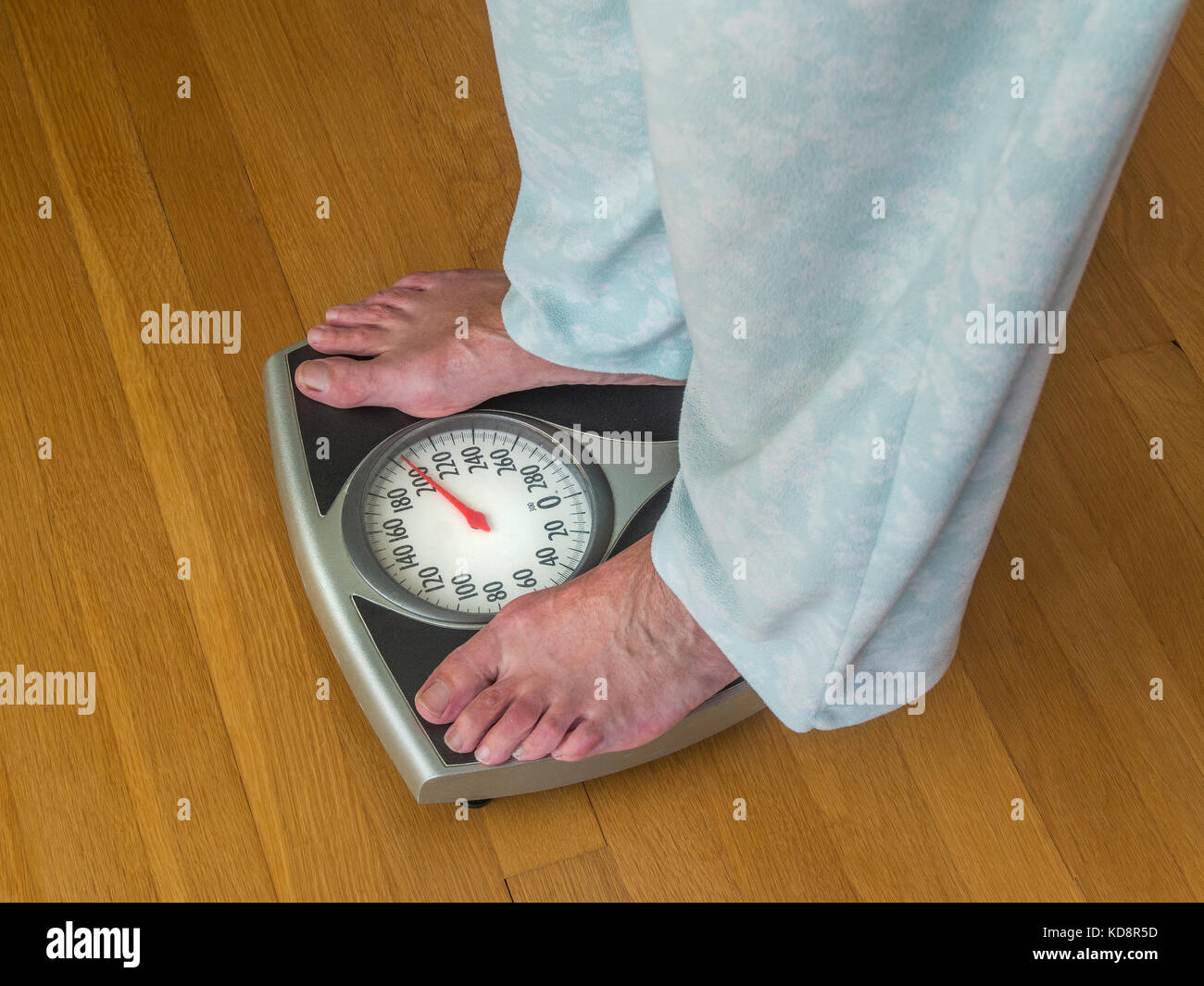 Overweight woman on a bathroom scale Stock Photo