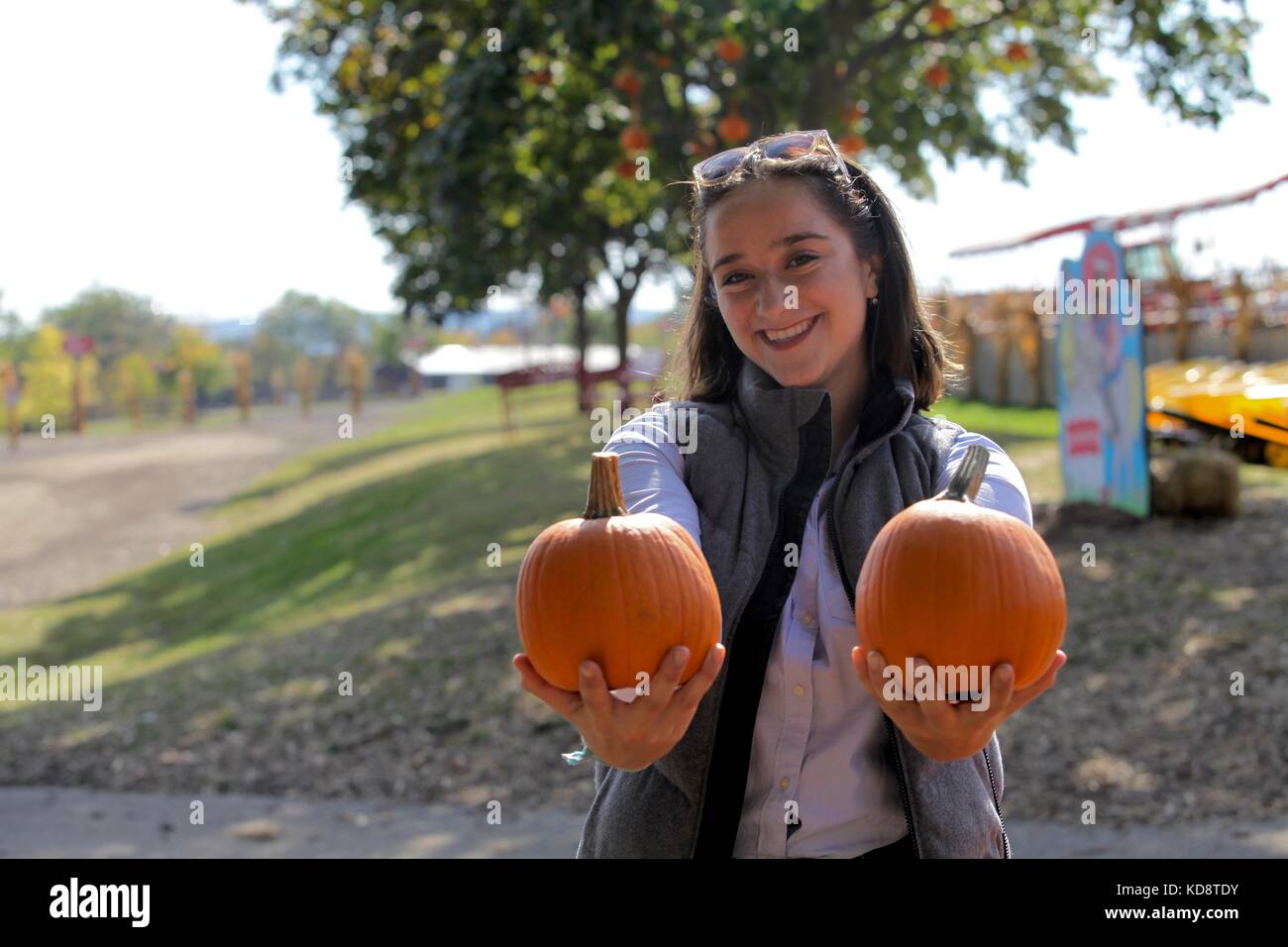 Women holding two small pumpkins on a farm Stock Photo