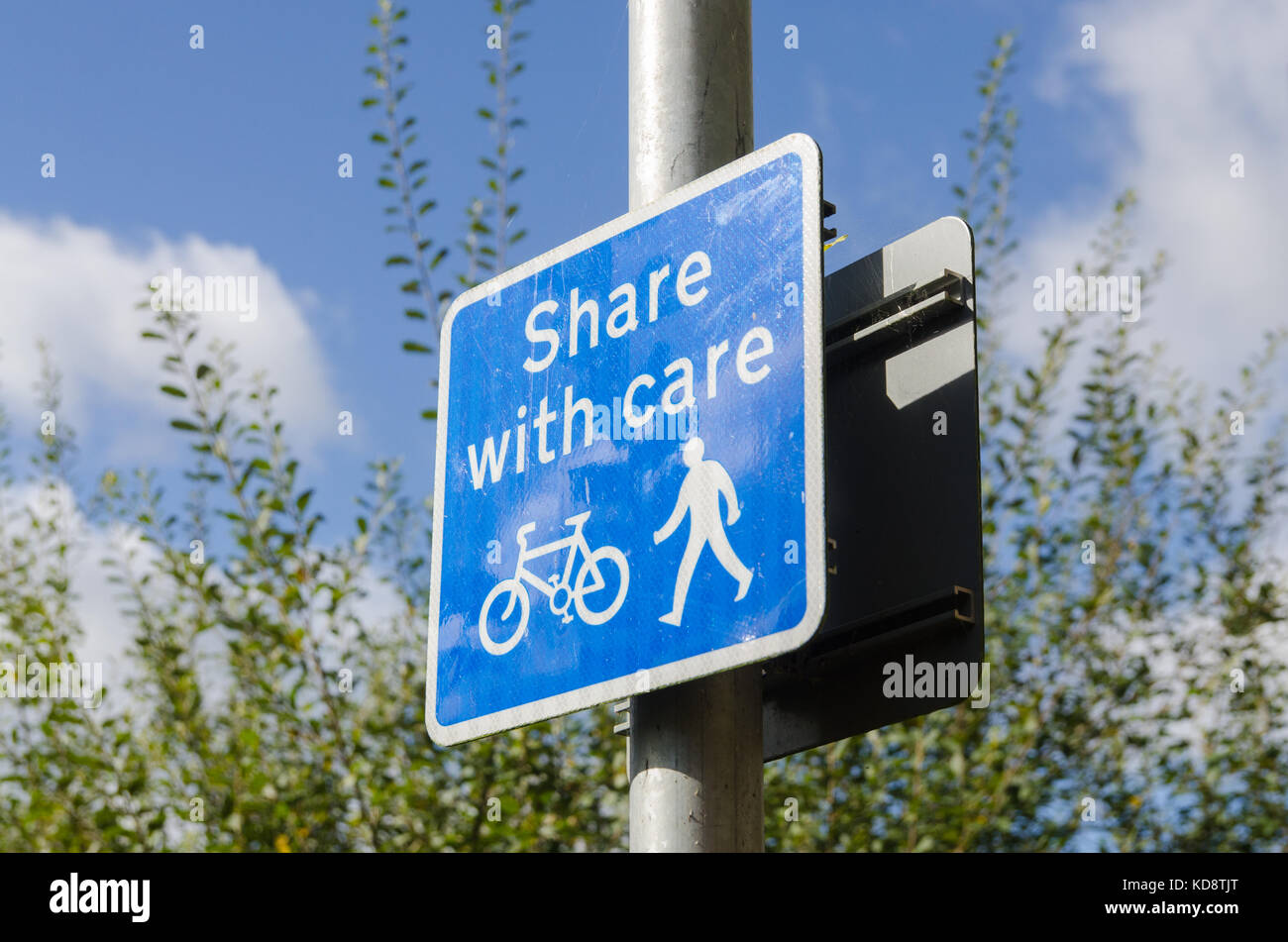 'Share with care' sign urging pedestrians and cyclists to take care and watch out on a path along the river severn in Worcester Stock Photo