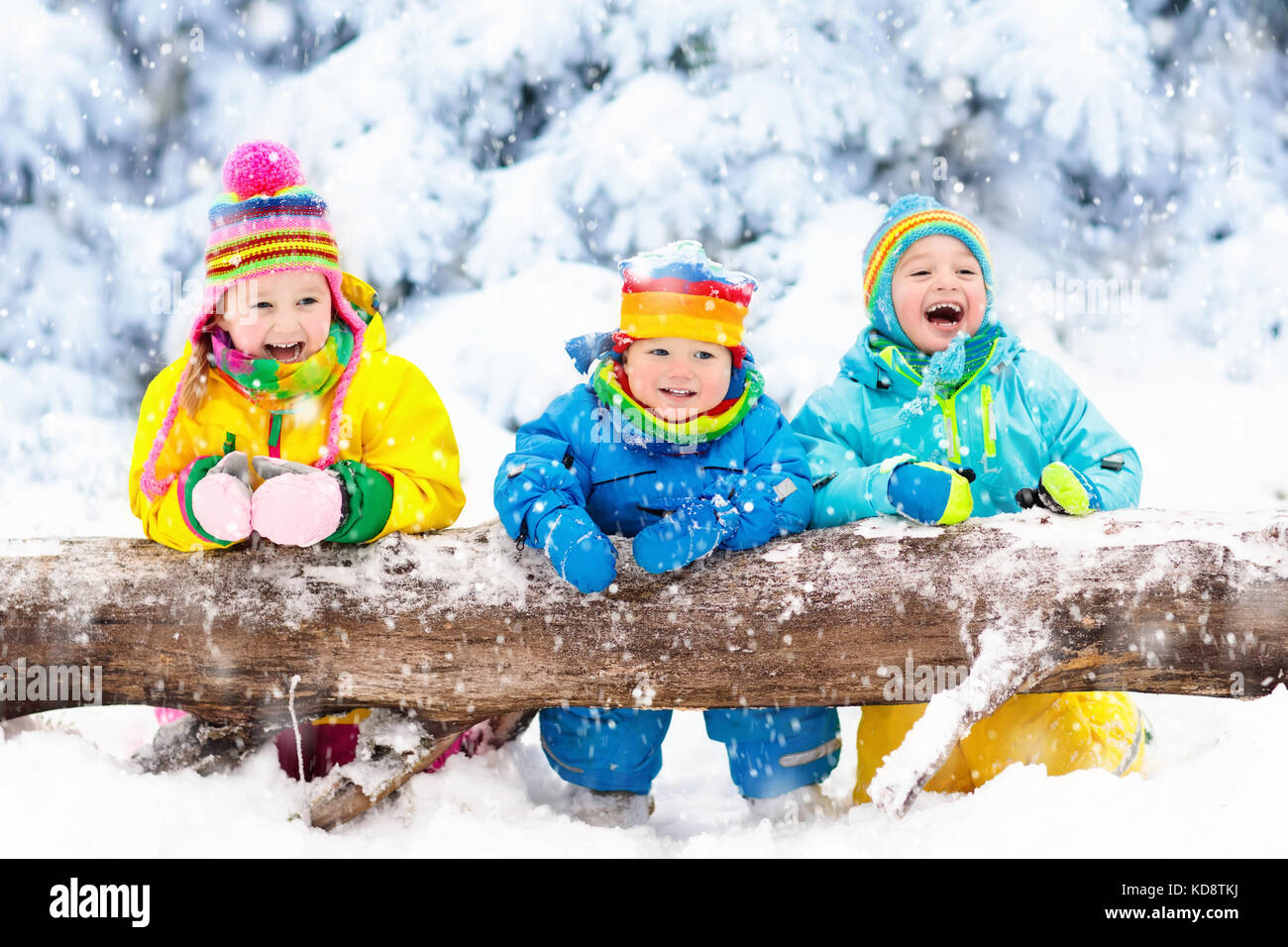 Kids playing in snow. Children play outdoors on snowy winter day. Boy ...