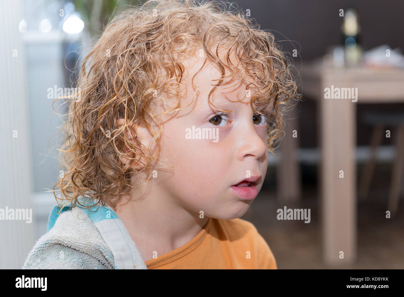 Portrait Of A Little Boy With Blond And Curly Hair Stock Photo