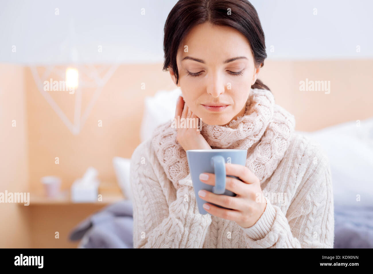 Sad woman having a terrible sore throat Stock Photo