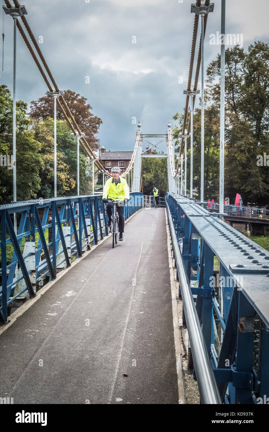 A cyclist on Teddington Lock Footbridge on the River Thames, Teddington, England, UK Stock Photo