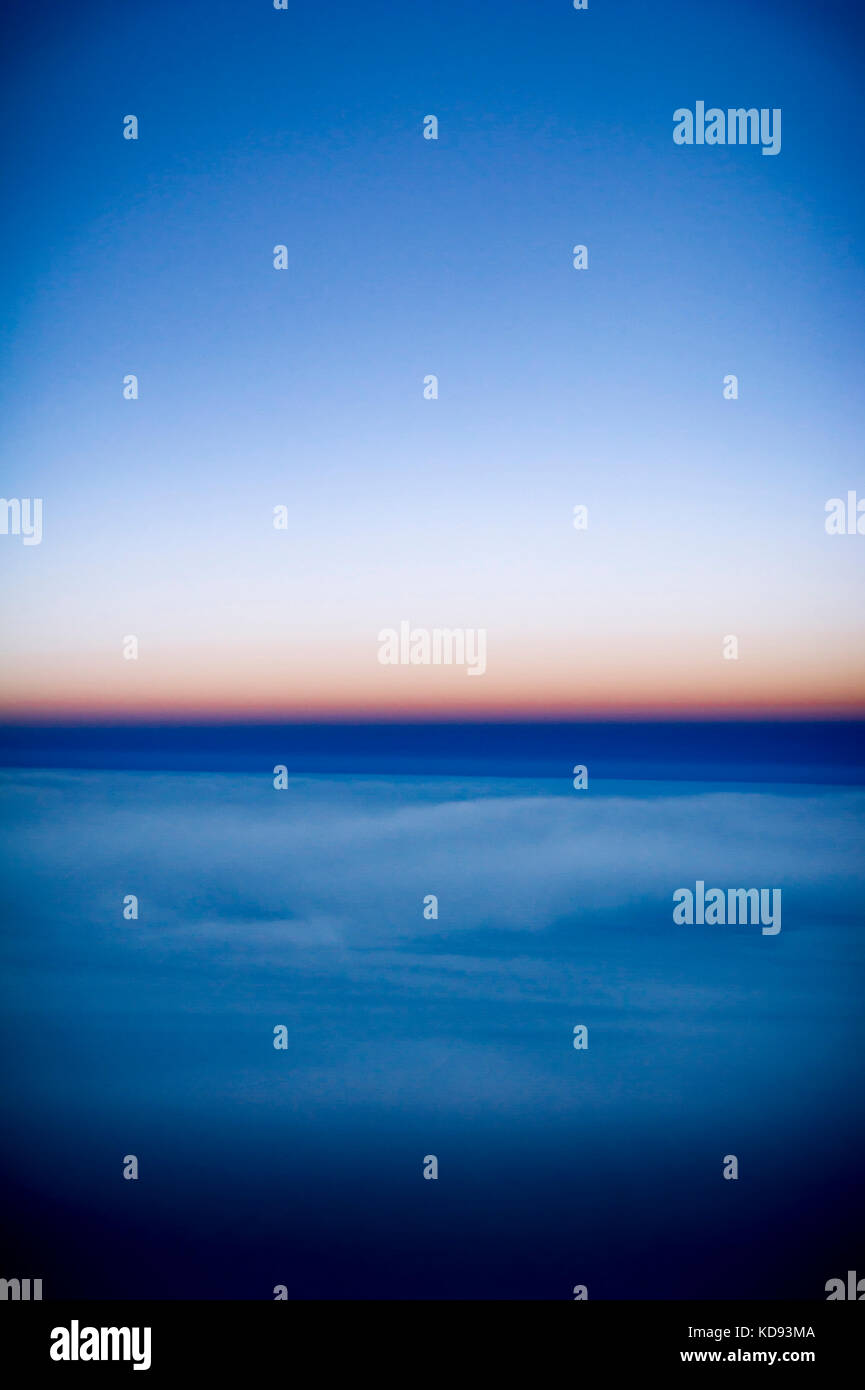 View of the clouds and sky above from the airplane window Stock Photo ...