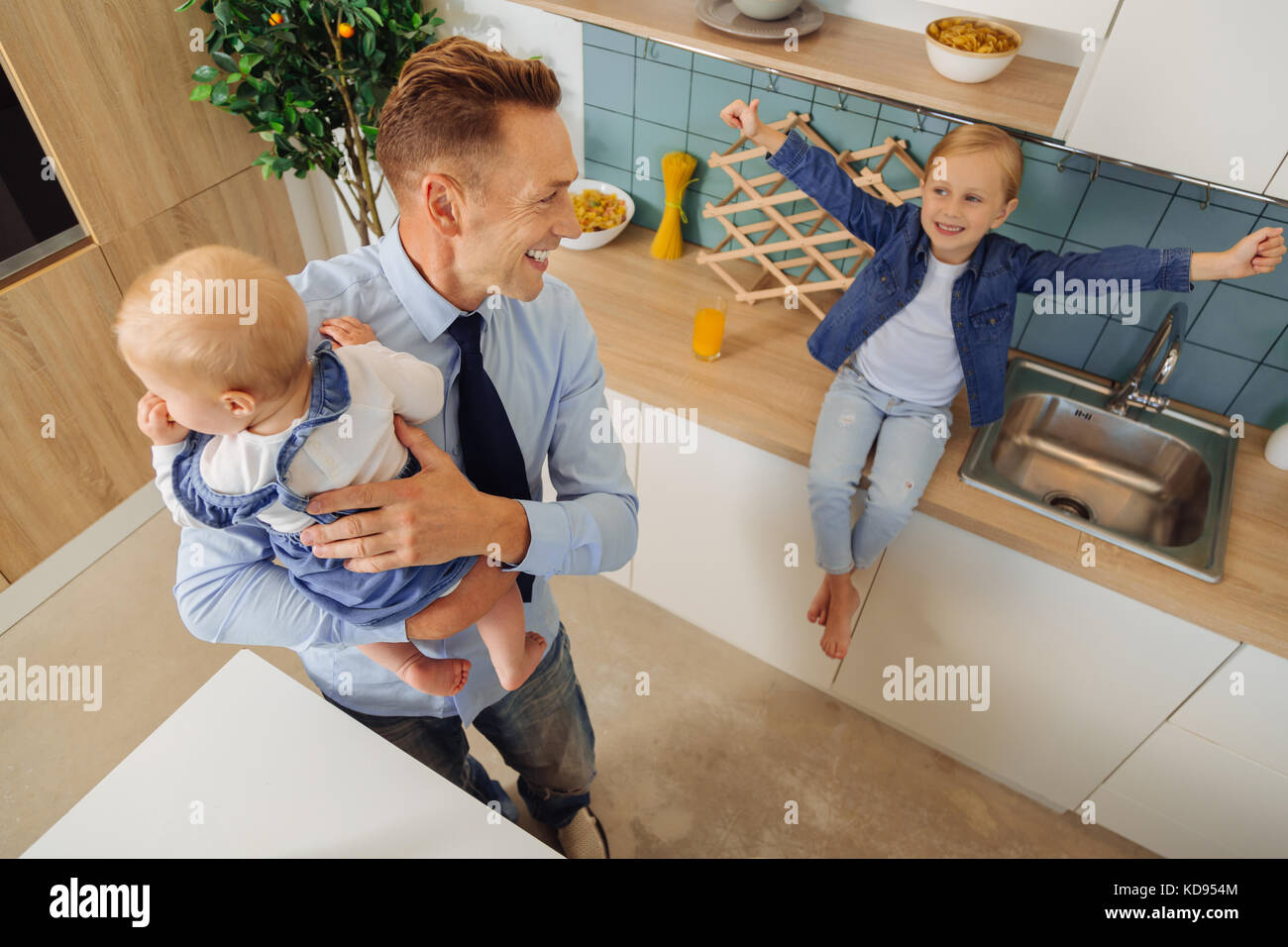 Delighted cheerful man having fun with his daughter Stock Photo - Alamy