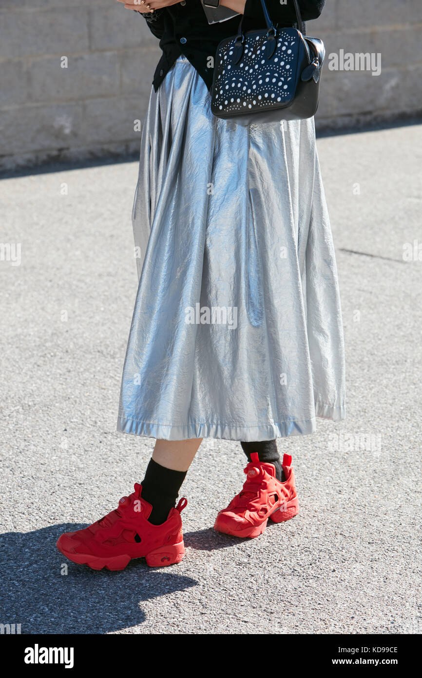 MILAN - SEPTEMBER 20: Woman with silver metallic skirt and red Reebok  sneakers before Alberto Zambelli fashion show, Milan Fashion Week street  style o Stock Photo - Alamy