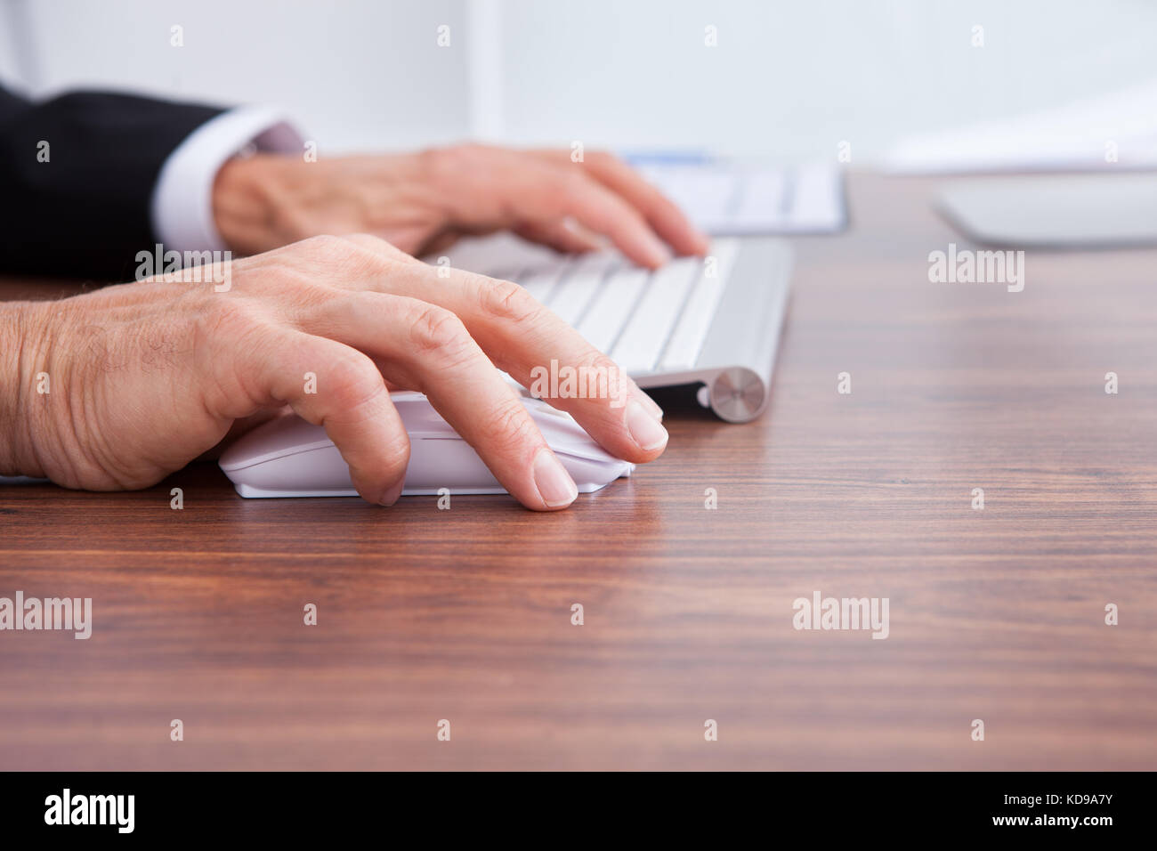 Close-up Of Businessman's Hand Using Computer At Desk Stock Photo - Alamy