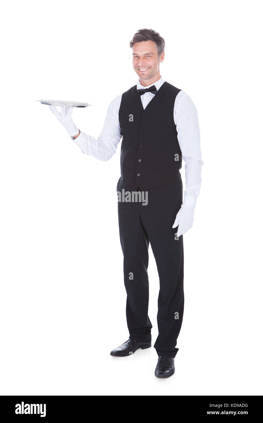 Portrait Of Happy Male Waiter Holding Empty Tray Stock Photo