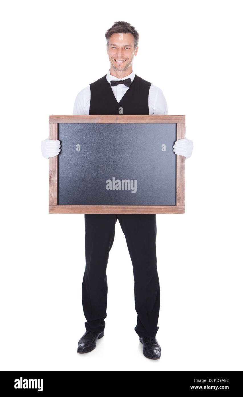 Portrait Of A Happy Smiling Waiter Holding Blank Chalkboard Stock Photo