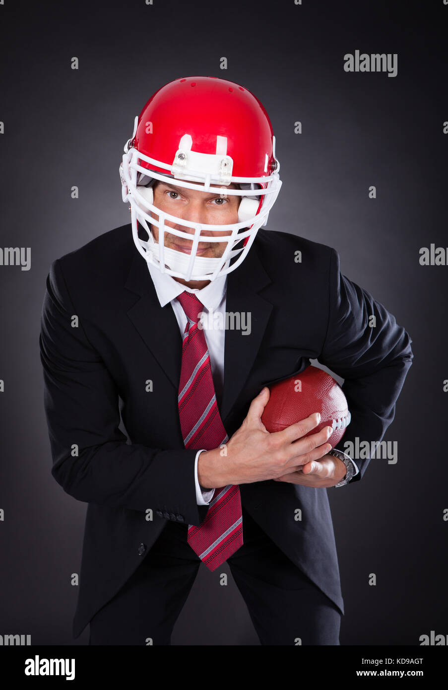 Mature Businessman Wearing Helmet Holding Rugby Ball Stock Photo Alamy
