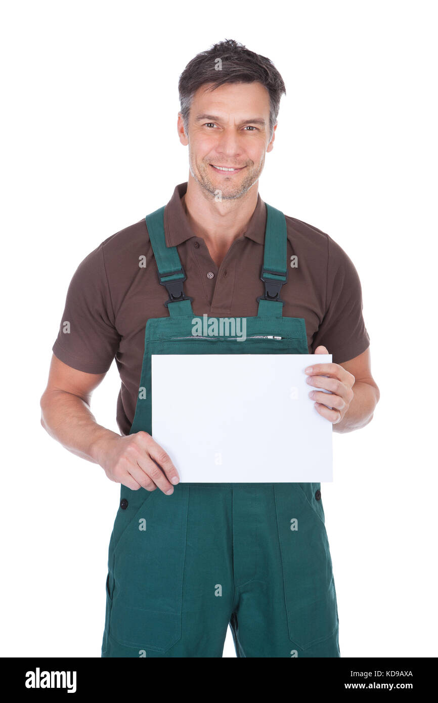 Portrait Of Mature Male Gardener Holding Blank Placard Over White Background Stock Photo