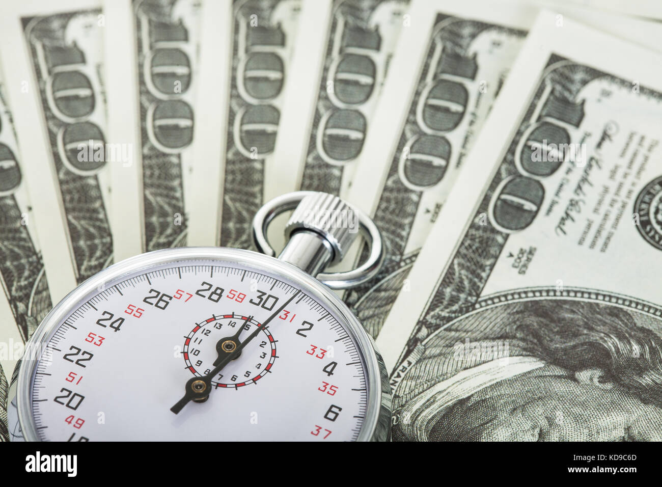 Stopwatch and dollars. Time is money concept Stock Photo - Alamy