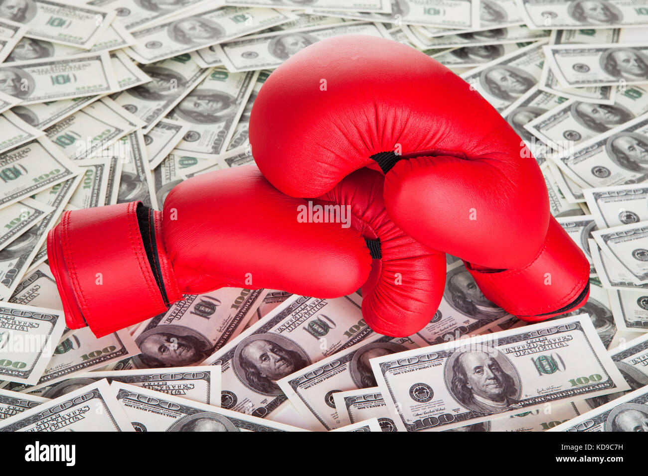 Boxing gloves on top of 100 dollars bills Stock Photo Alamy