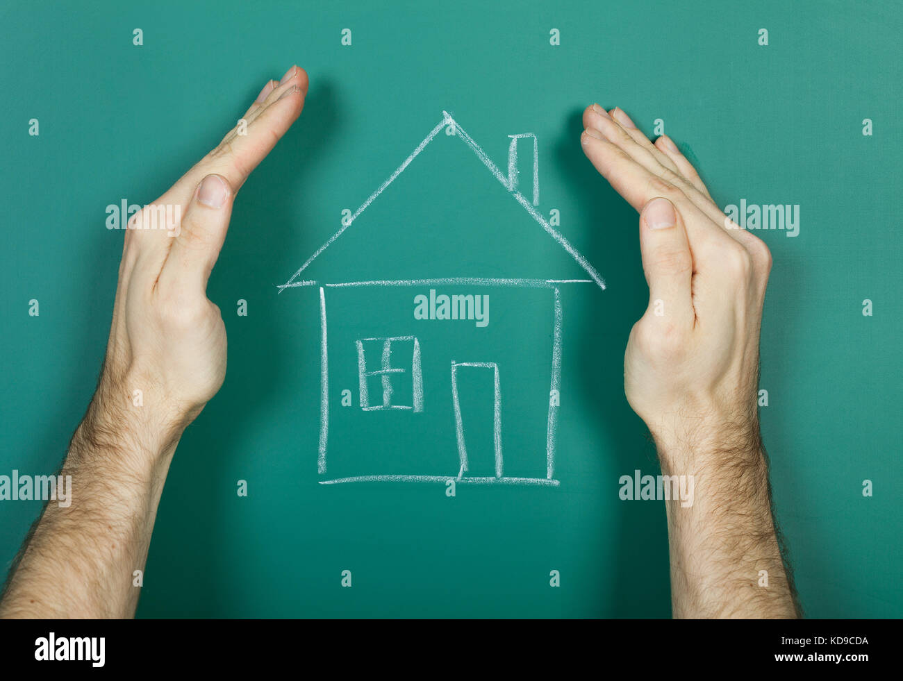 Hand holding chalk drawing house on blackboard Stock Photo Alamy
