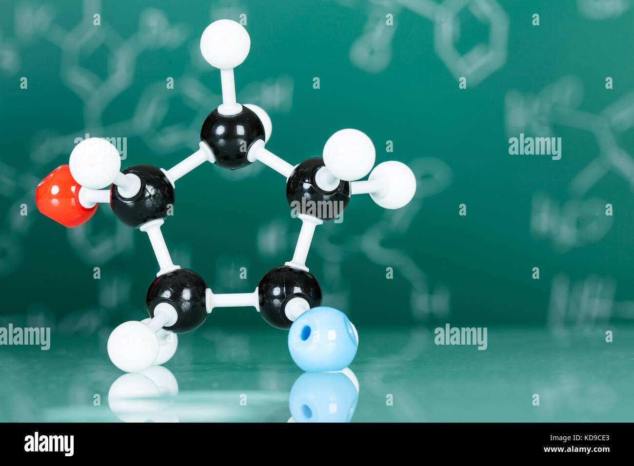 Model of molecular structure on green reflective background Stock Photo