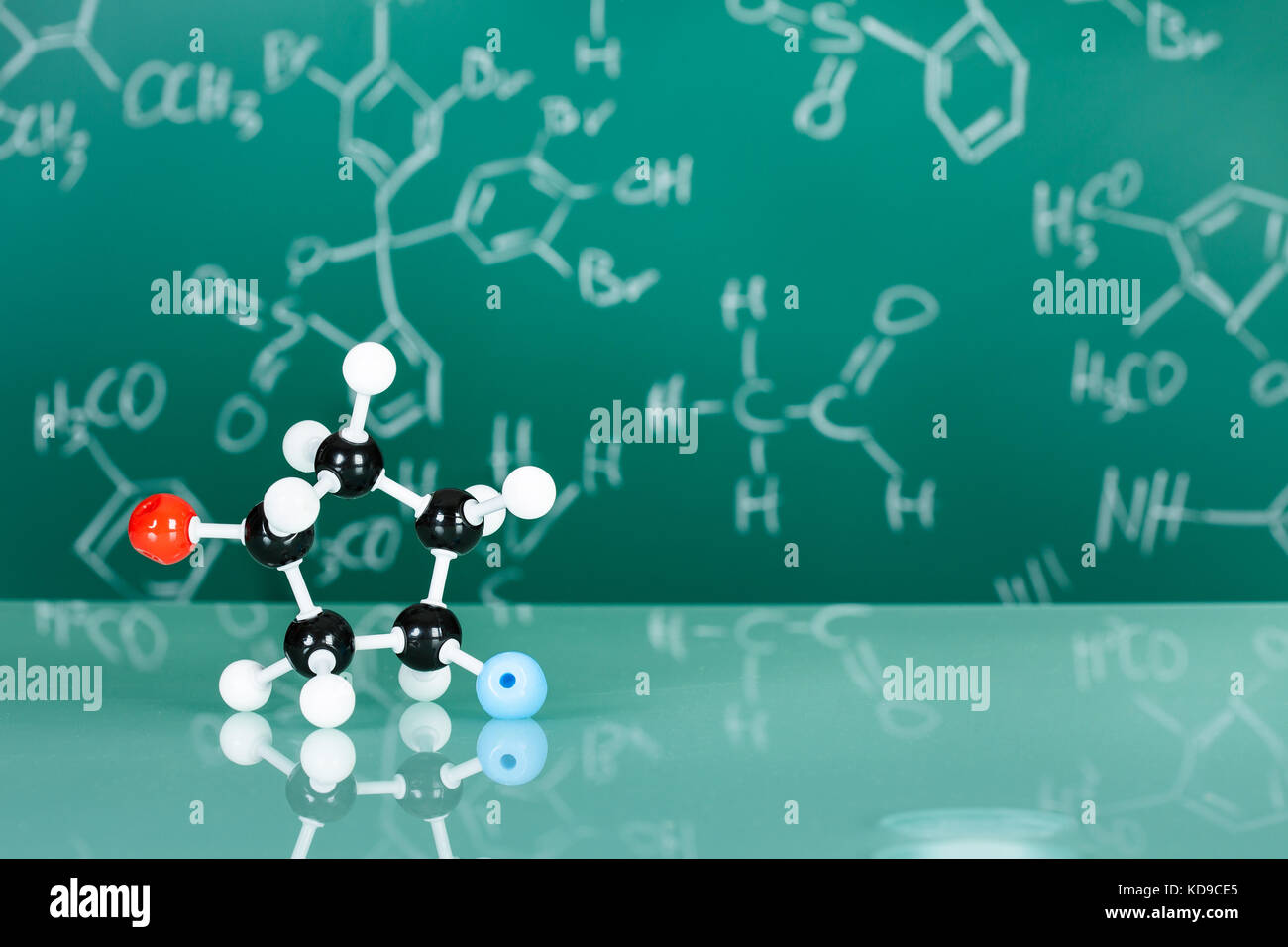Model of molecular structure on green reflective background Stock Photo