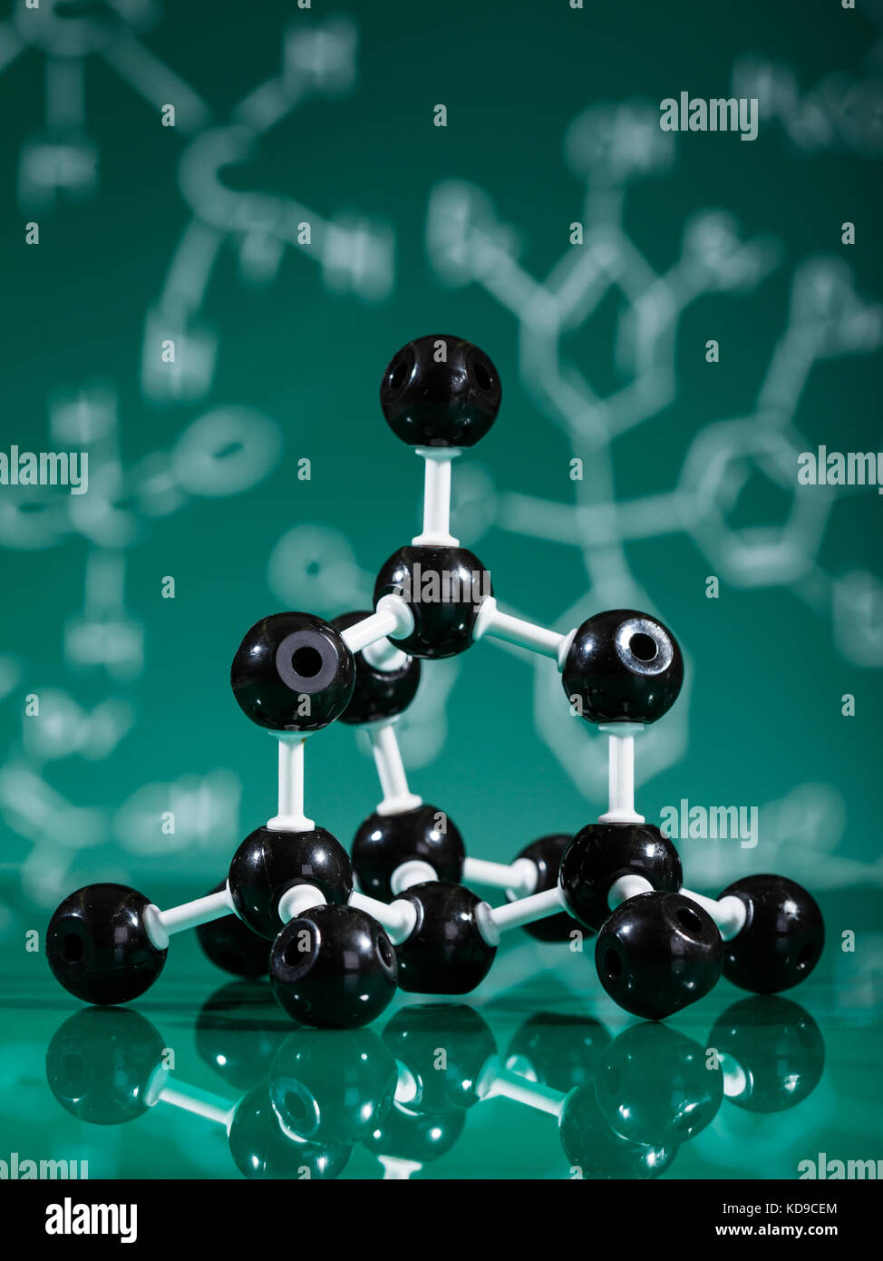 Model of graphite molecular structure on green reflective background