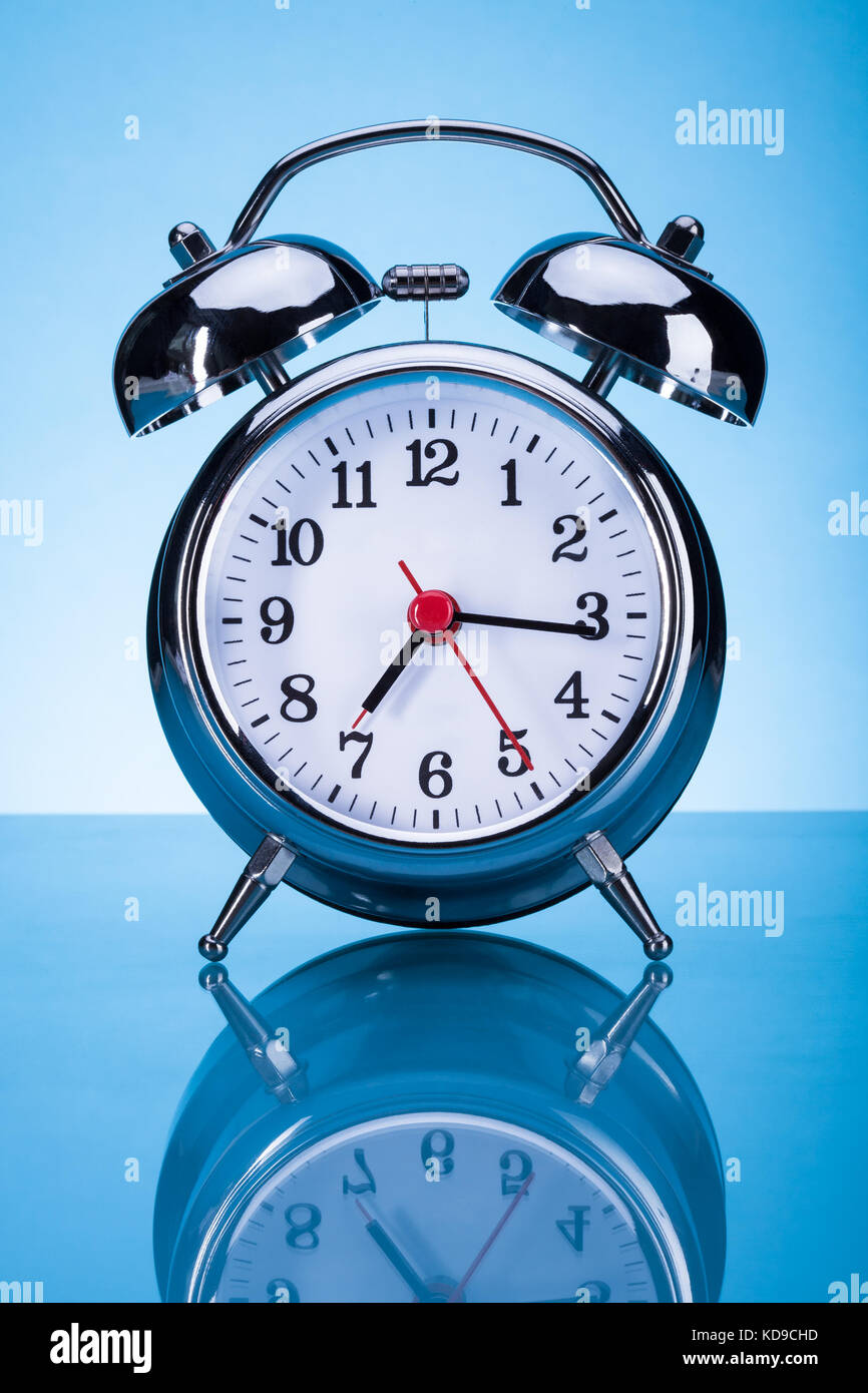 Photo Of Alarm Clock Over Blue Background Stock Photo - Alamy