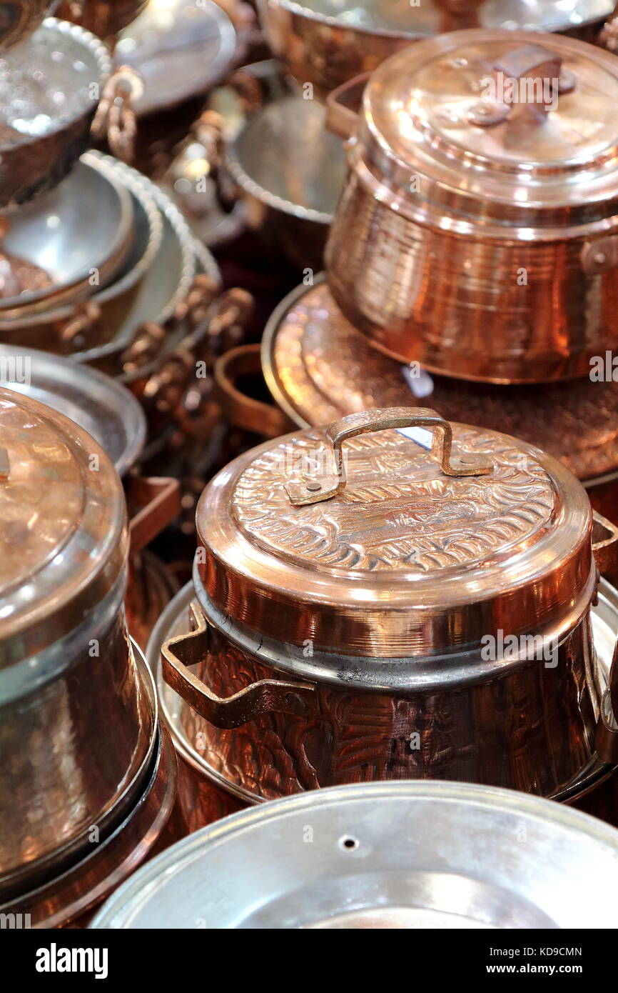 Shiny copper cookware, comprising pots, pans, soucepans. Picture taken