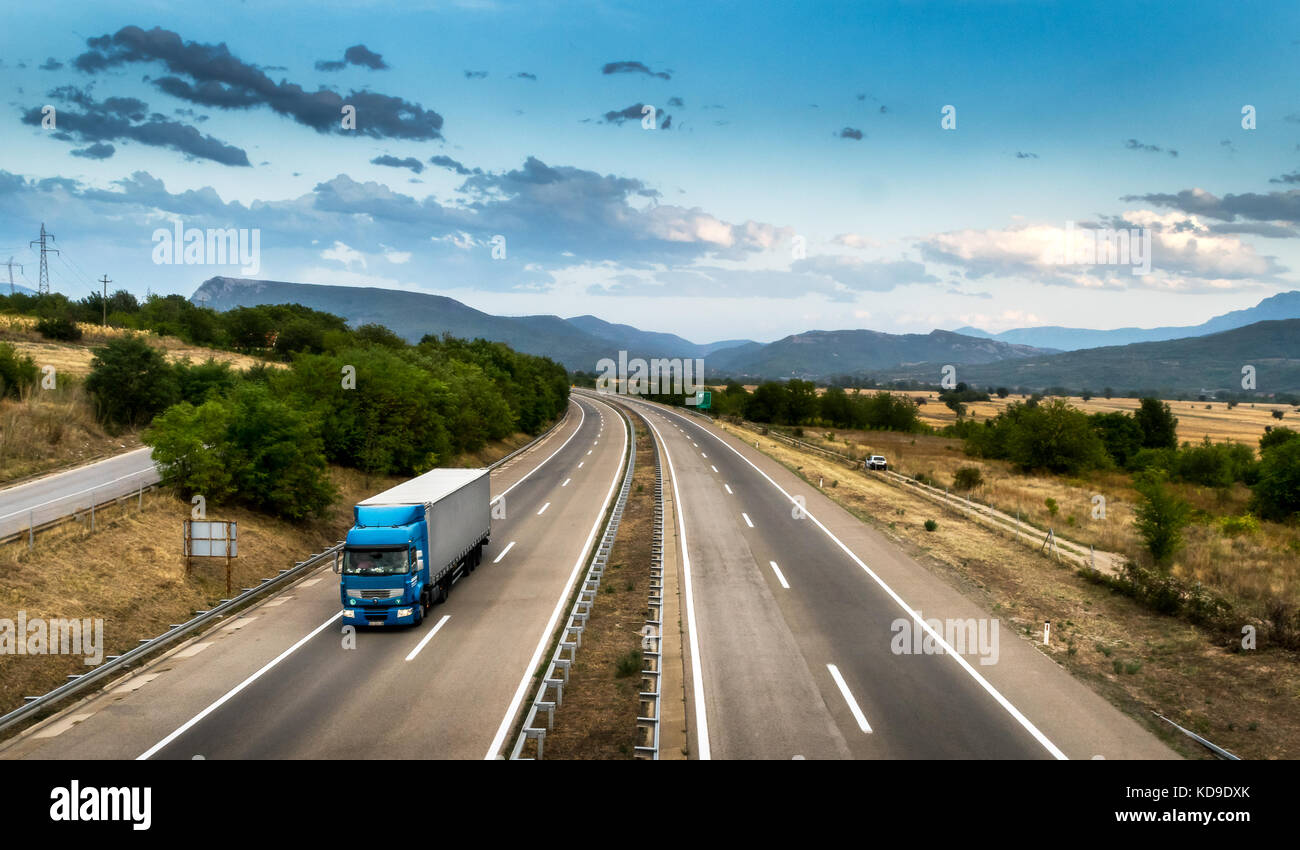 Blue truck in motion on the highway Stock Photo