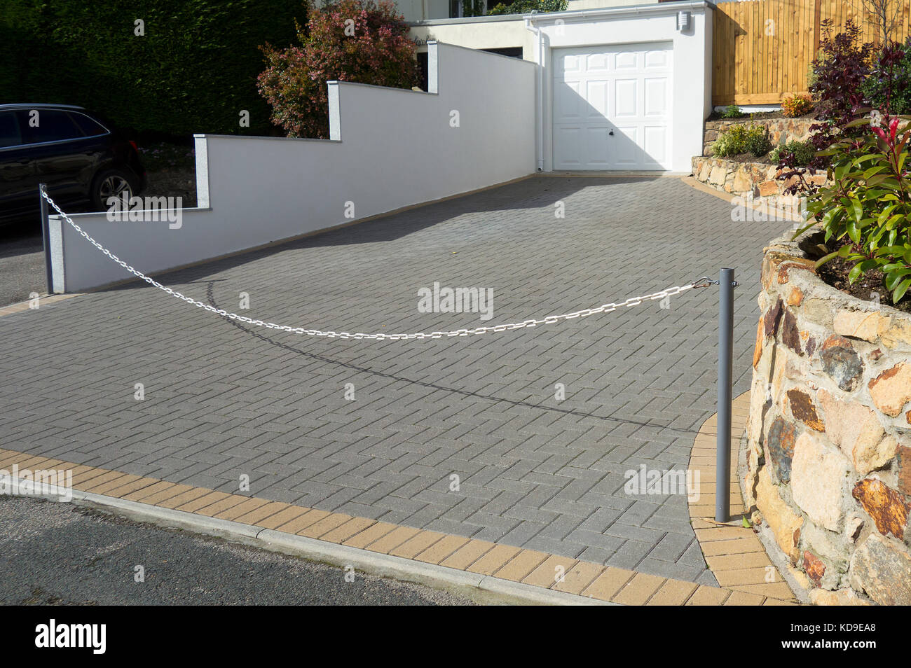 a garden paved with concrete blocks to make a driveway. Stock Photo