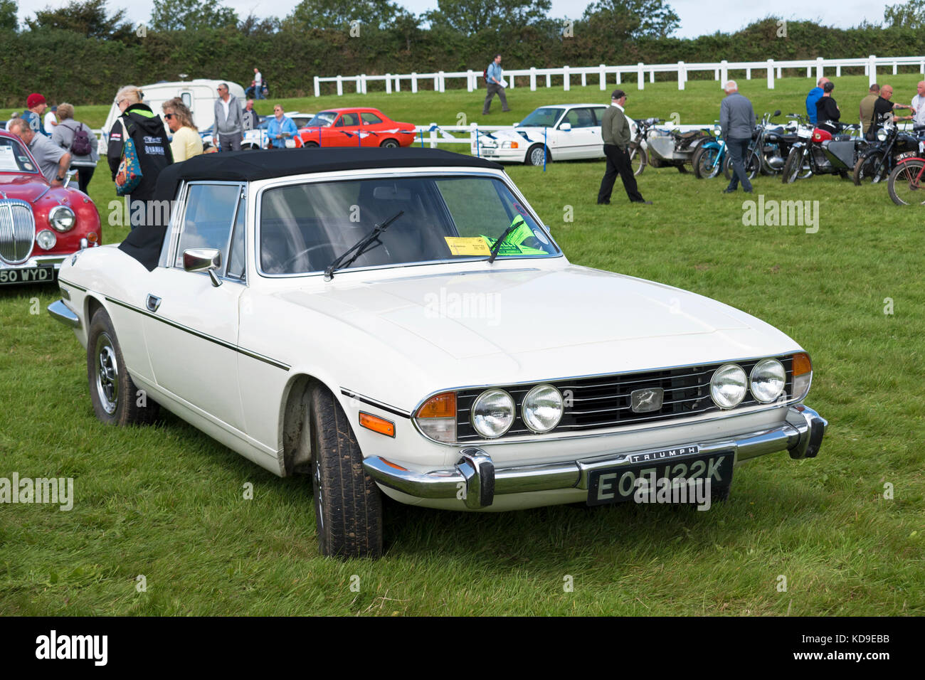 a white with a black soft top triumph stag at vintage car rally Stock Photo