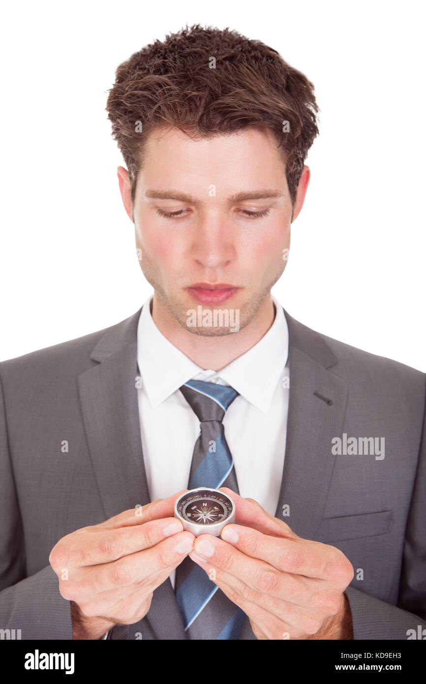 Close-up Of Young Businessman Looking At Compass Stock Photo