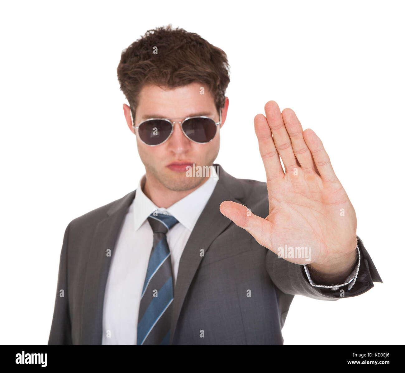 Portrait Of Young Businessman Gesturing On White Background Stock Photo