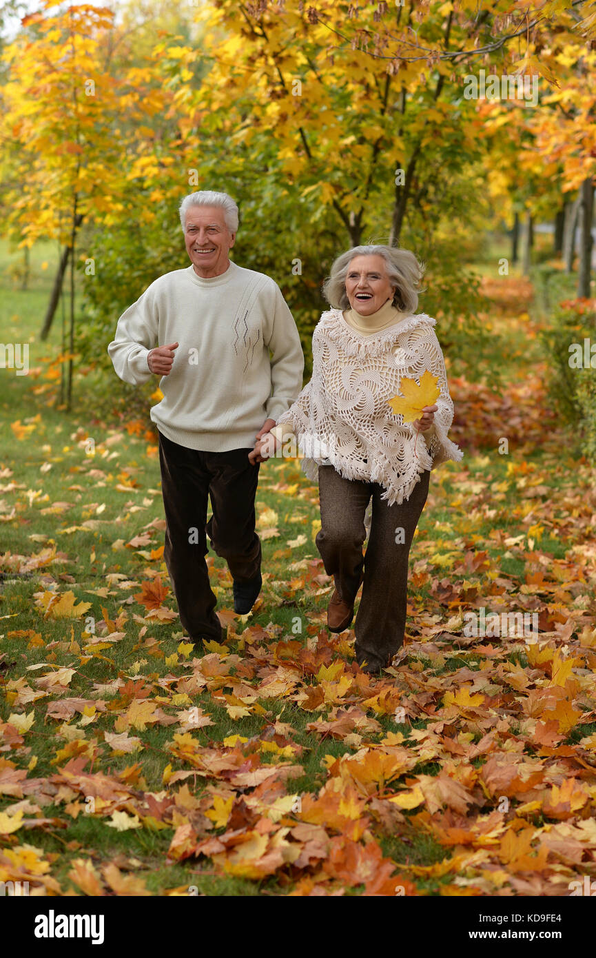 Senior couple running in park Stock Photo - Alamy