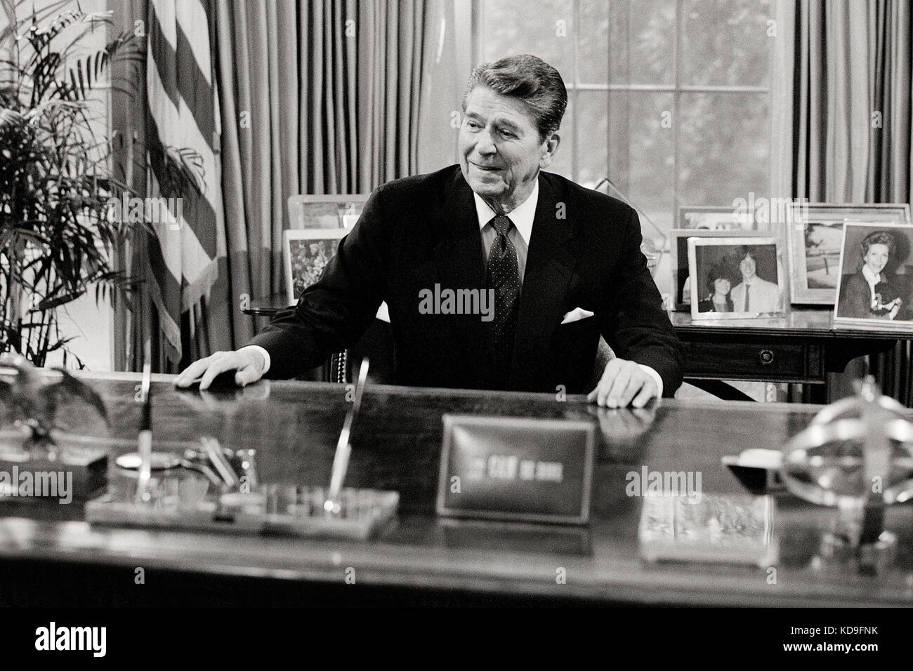 President Ronald Reagan at his desk in the White House Oval Office. Stock Photo