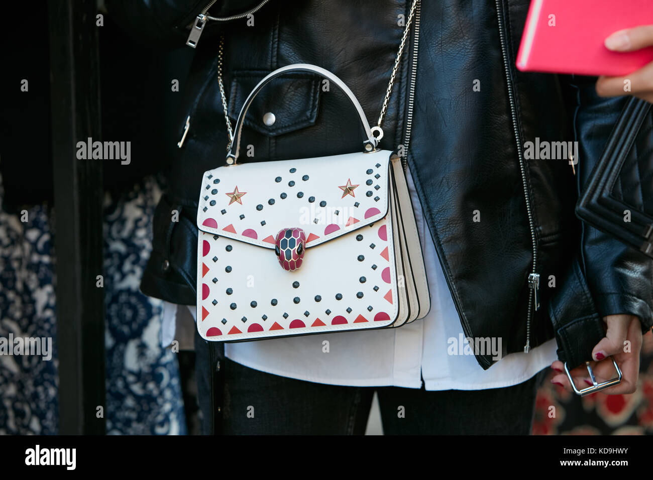 MILAN - SEPTEMBER 21: Woman with white Bulgari bag studs decorations and  black leather jacket before Max Mara fashion show, Milan Fashion Week  street Stock Photo - Alamy