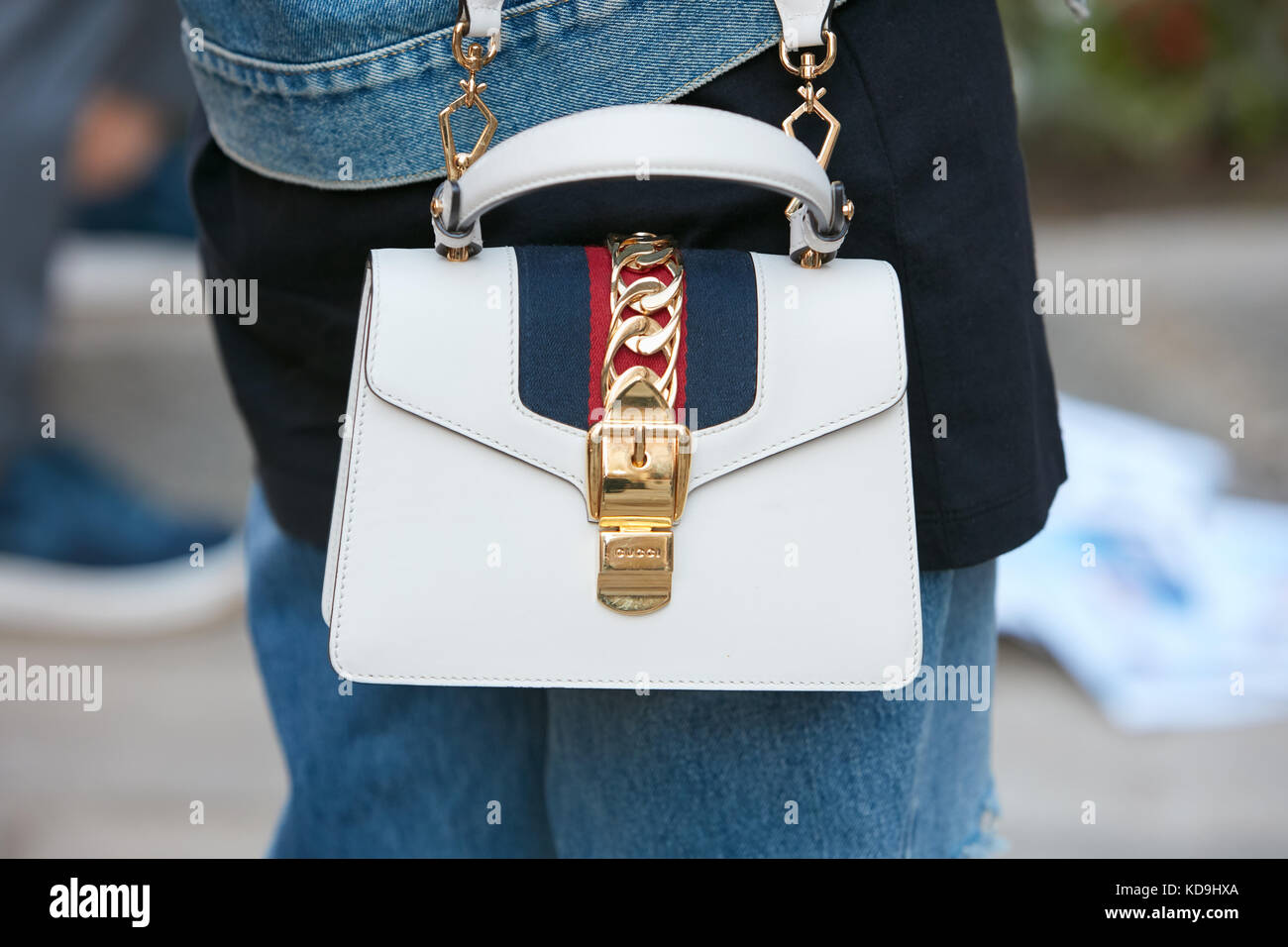 MILAN - SEPTEMBER 21: Woman with white leather Gucci bag with golden belt before Max Mara fashion show, Milan Fashion Week street style on September 2 Stock Photo