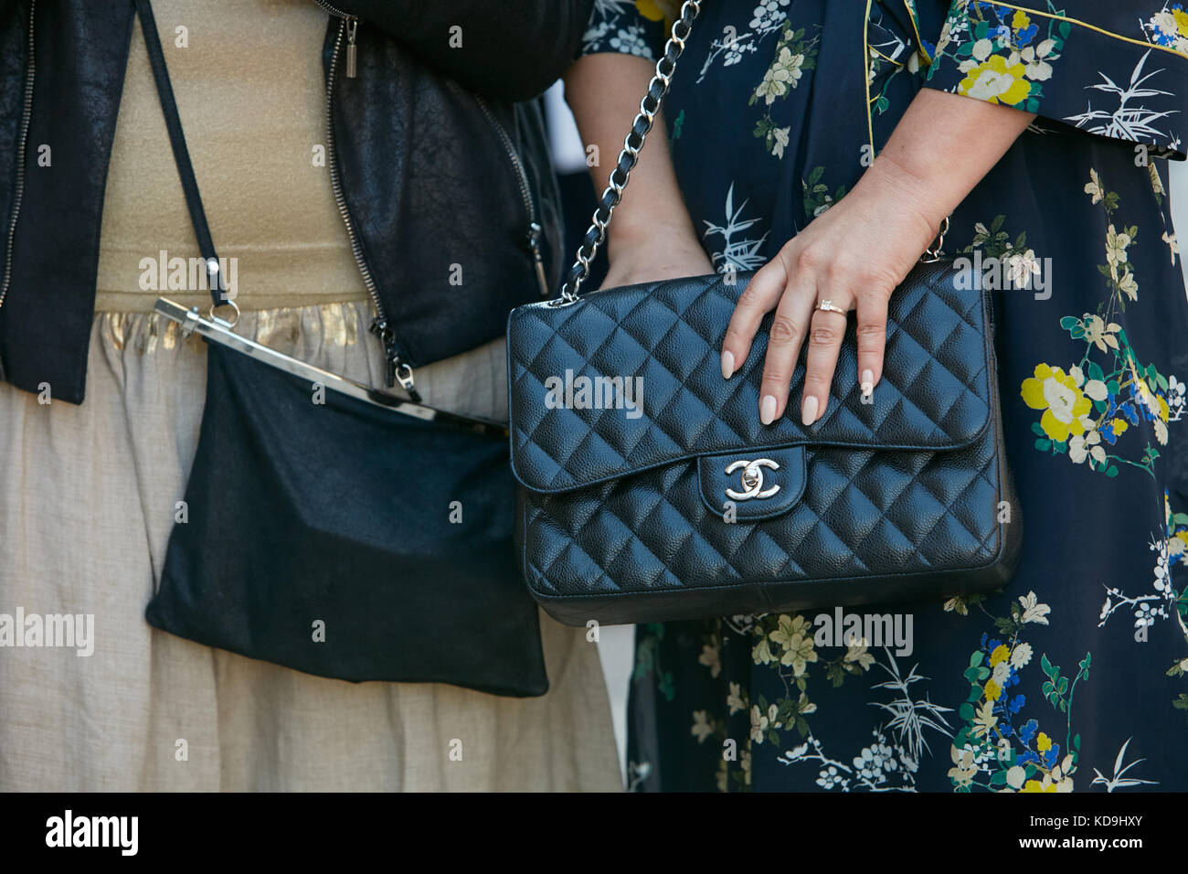 MILAN - SEPTEMBER 21: Women with Chanel black leather bag and floral dress  before Max Mara fashion show, Milan Fashion Week street style on September  Stock Photo - Alamy