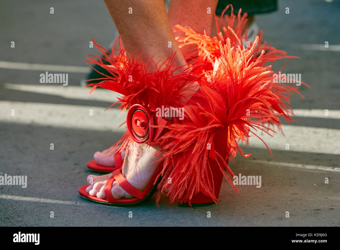 MILAN - SEPTEMBER 21: Woman with red Prada shoes with feathers before Prada  fashion show, Milan Fashion Week street style on September 21, 2017 in Mil  Stock Photo - Alamy
