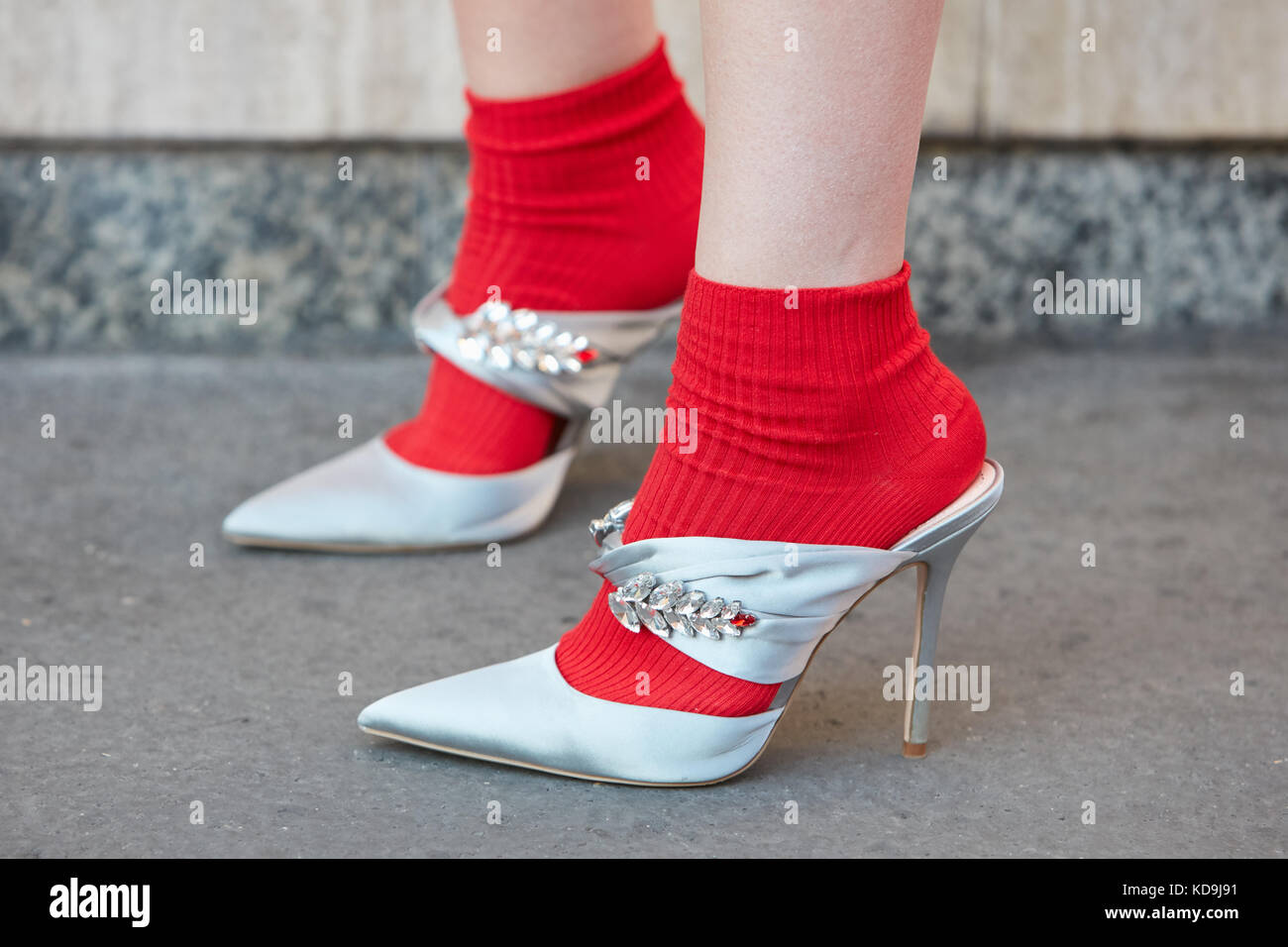 MILAN - SEPTEMBER 21: Woman with silver high heel shoes with gems  decoration and red socks before Prada fashion show, Milan Fashion Week  street style Stock Photo - Alamy