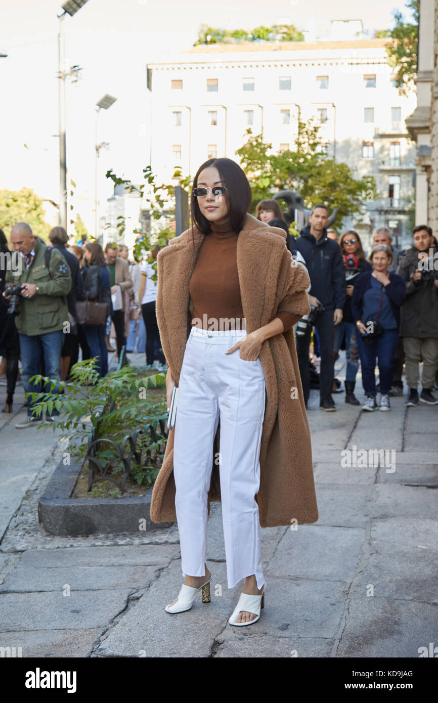MILAN - SEPTEMBER 21: Yoyo Cao with white trousers and brown fur coat before Max Mara fashion show, Milan Fashion Week street style on September 21, 2 Stock Photo