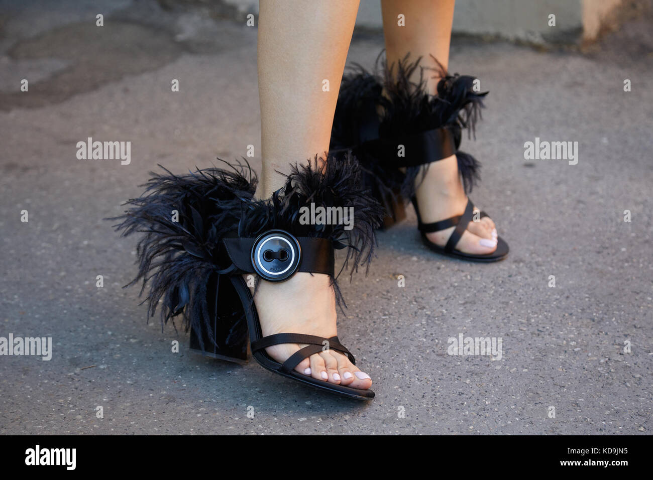 MILAN - SEPTEMBER 21: Woman with black Prada shoes with feathers before  Prada fashion show, Milan Fashion Week street style on September 21, 2017  in M Stock Photo - Alamy
