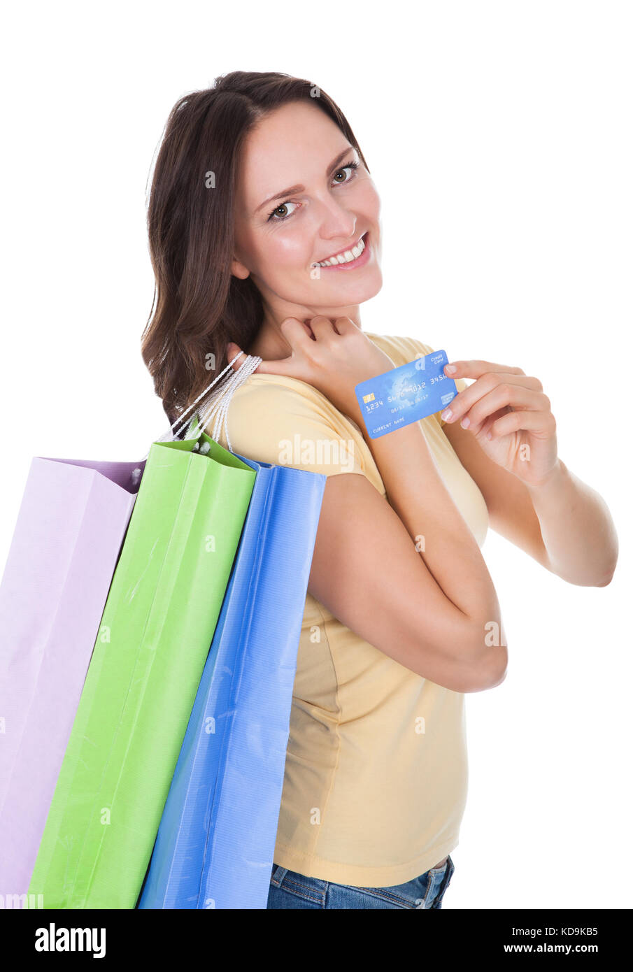 Smiling Woman With Shopping Bags Holding Credit Card Over White Background Stock Photo