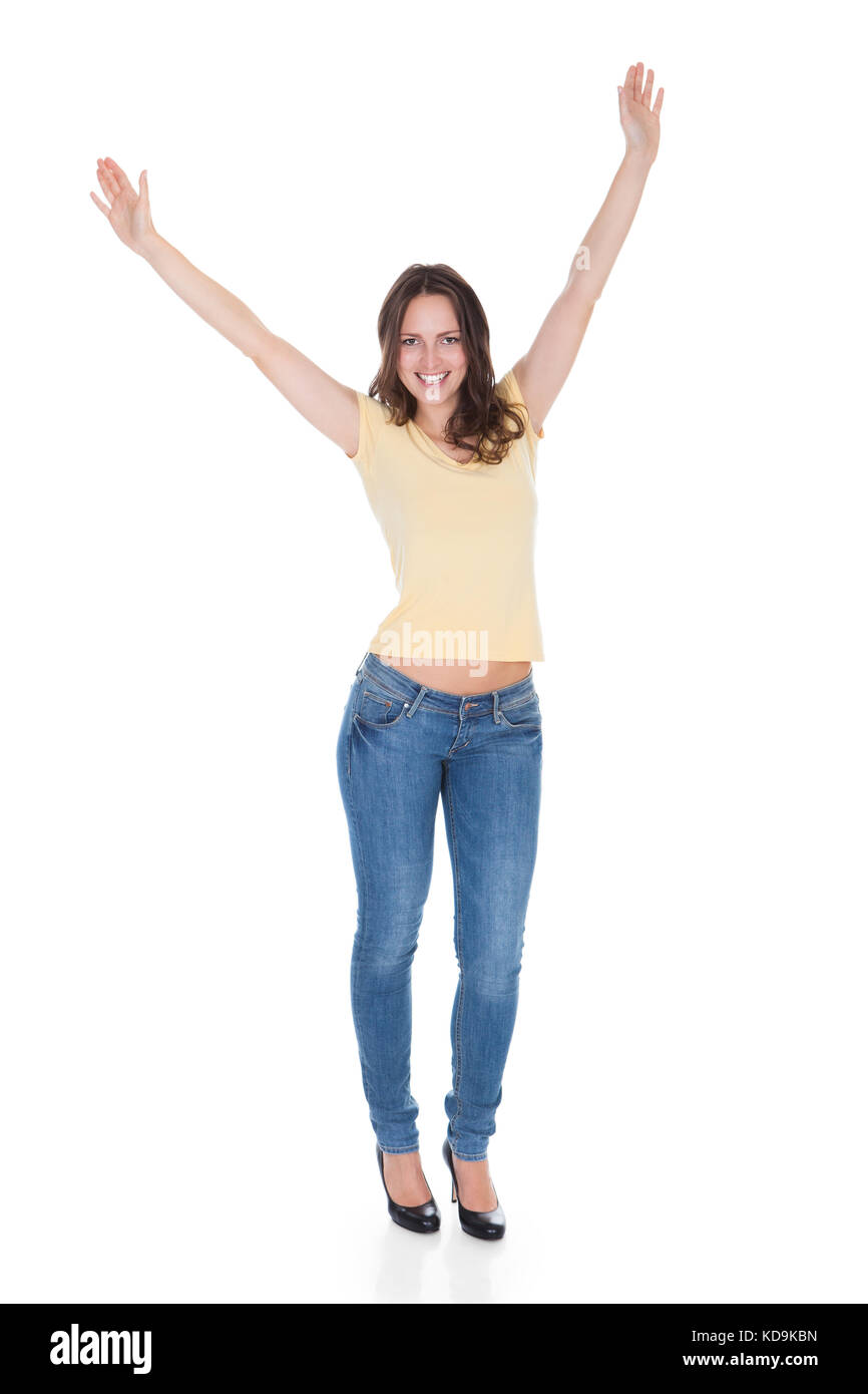 Portrait Of Carefree Young Woman With Hand Raised Over White Background Stock Photo