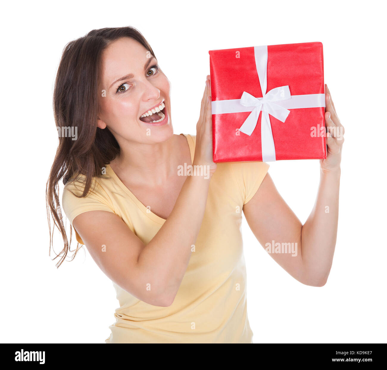 Portrait Of Smiling Young Woman Holding Red Gift Box Tied With White ...